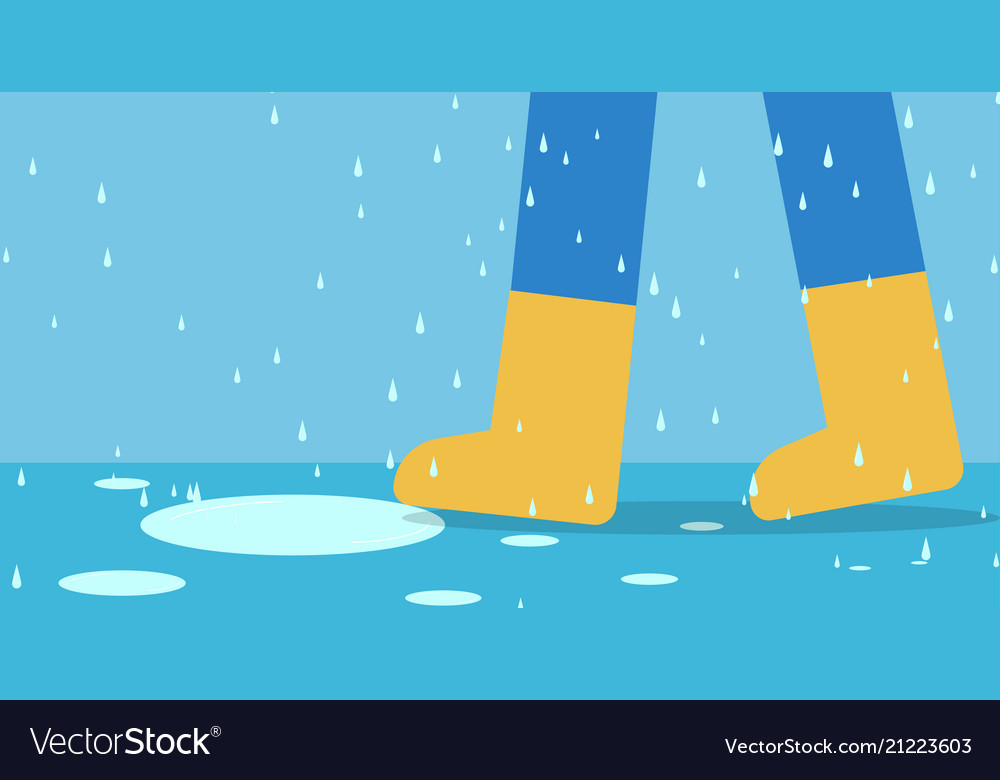 Feet of man in rain boots walk on road