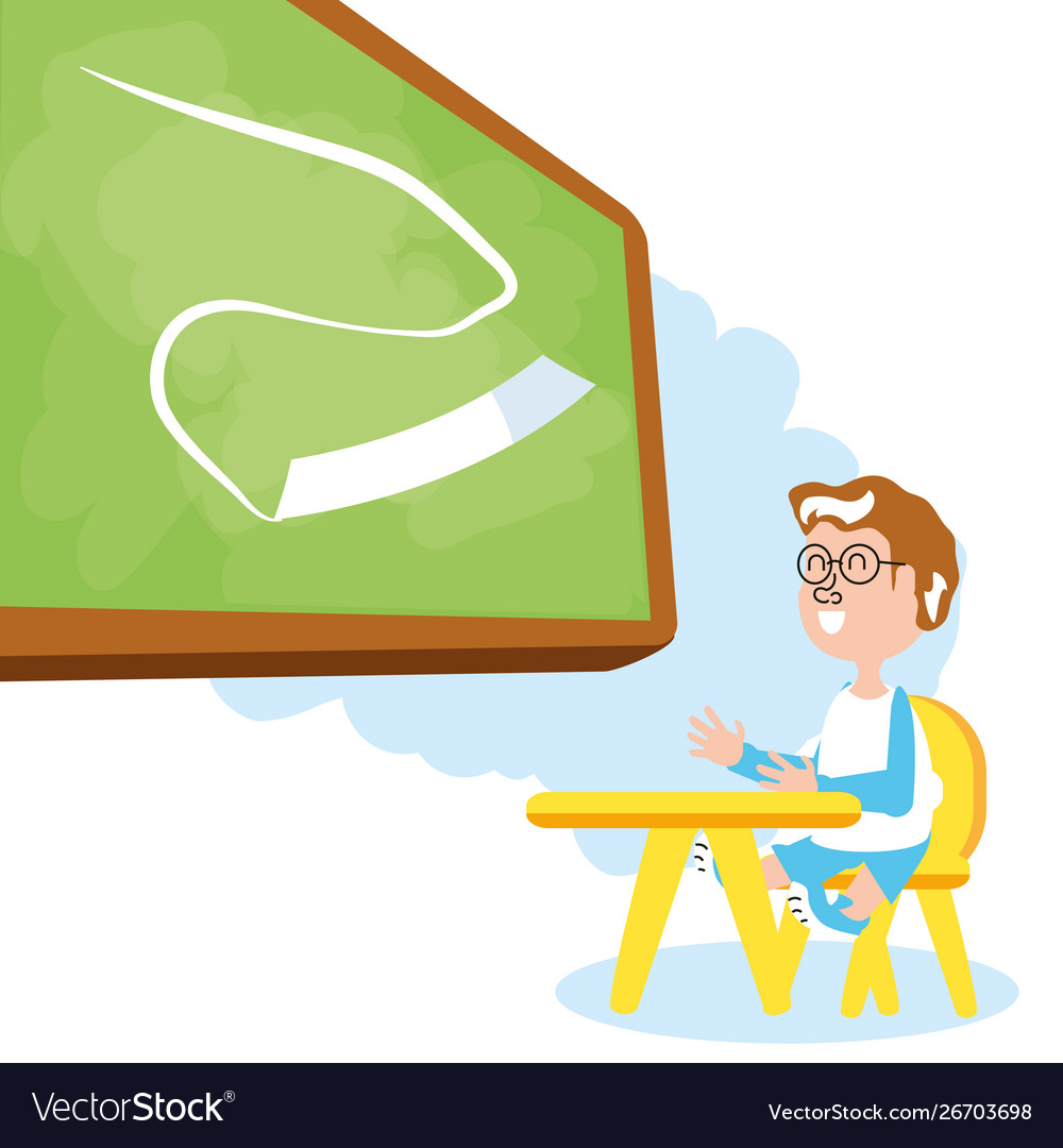 Little student boy sitting in school desk