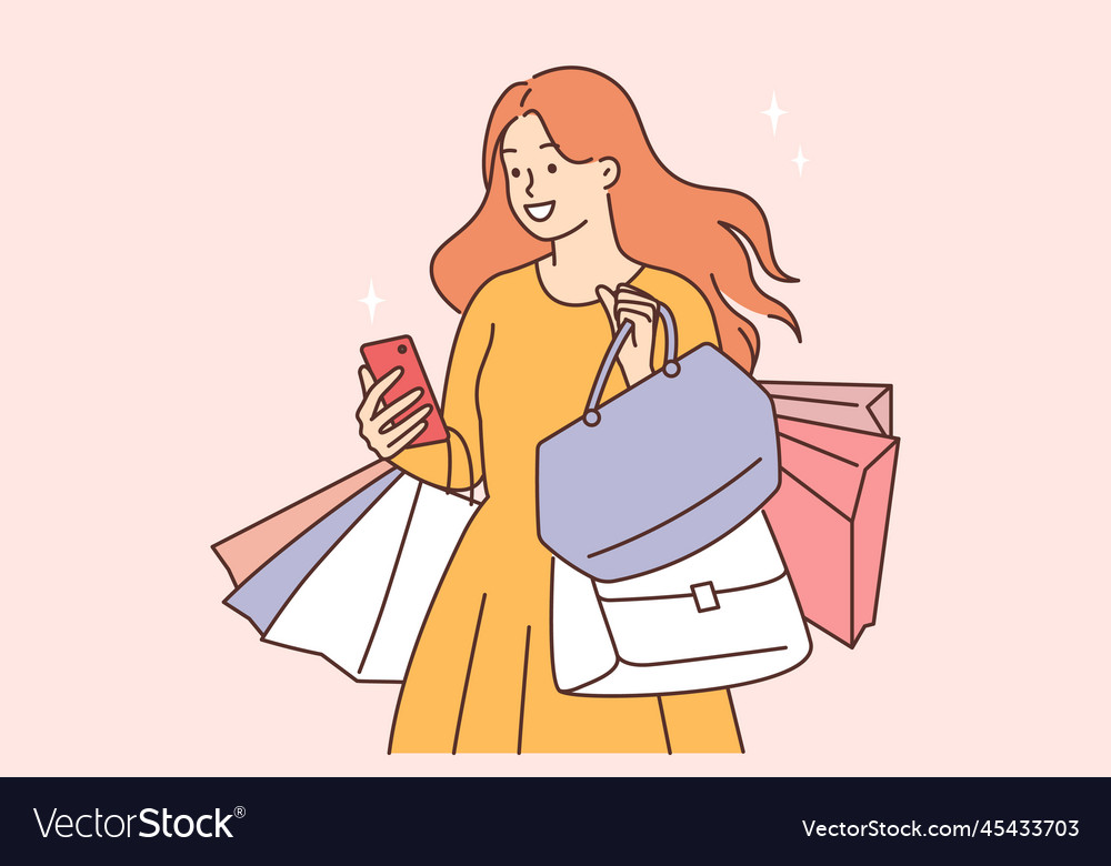 Smiling woman with shopping bags and cellphone