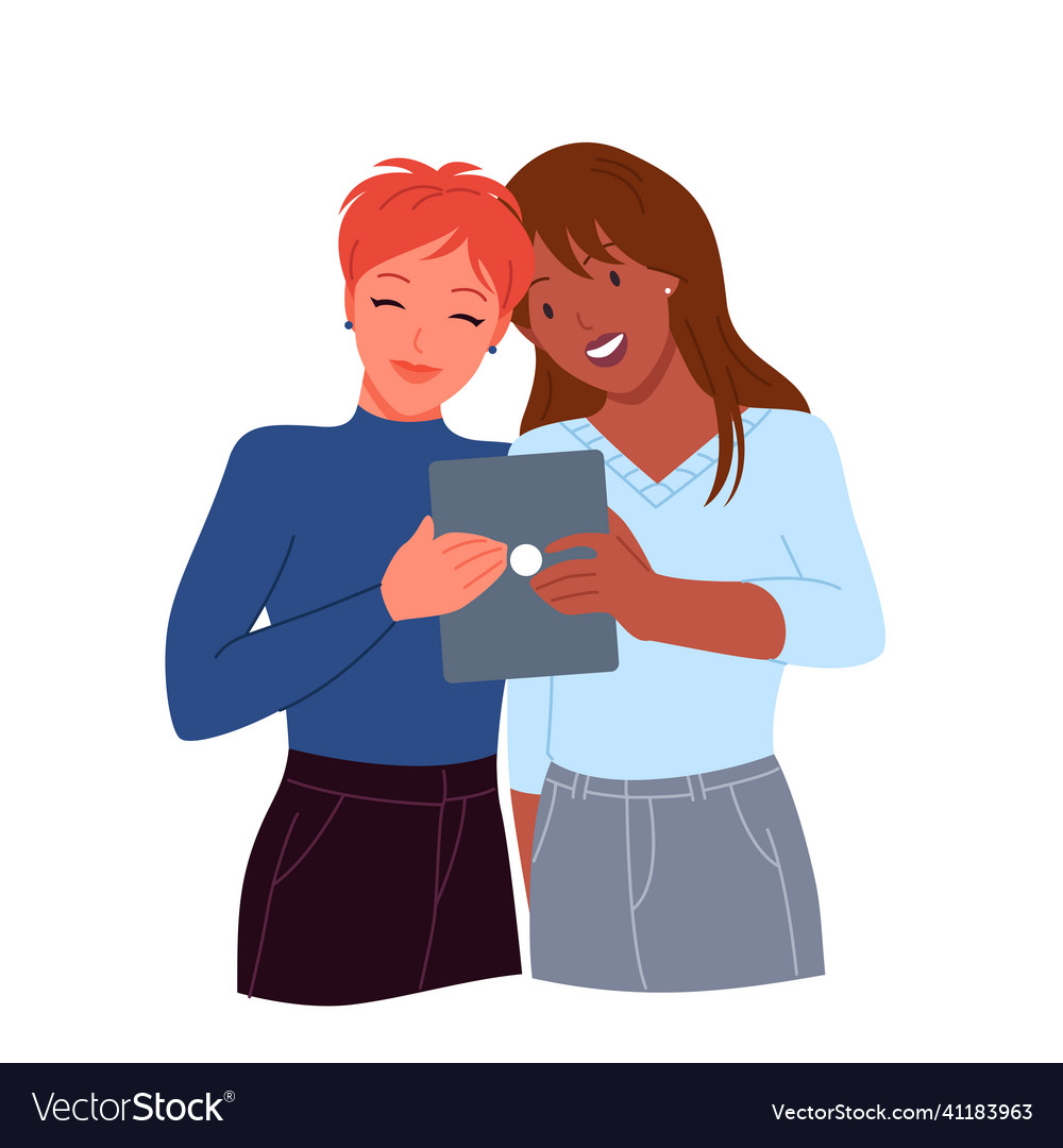 Happy couple of women holding tablet to take