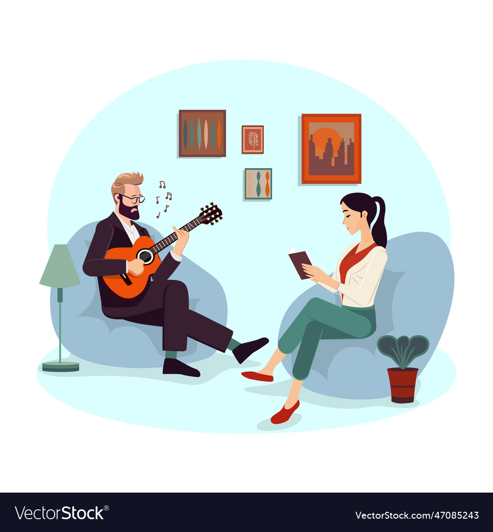 Man and woman sitting on sofa playing guitar