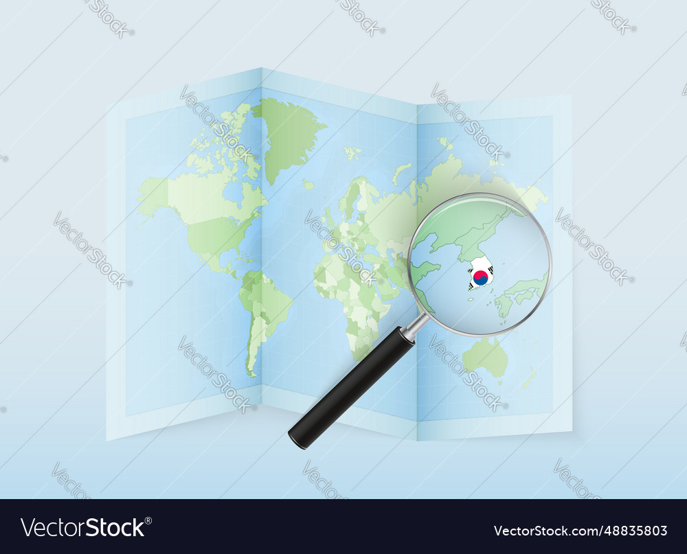 A folded world map with magnifying lens