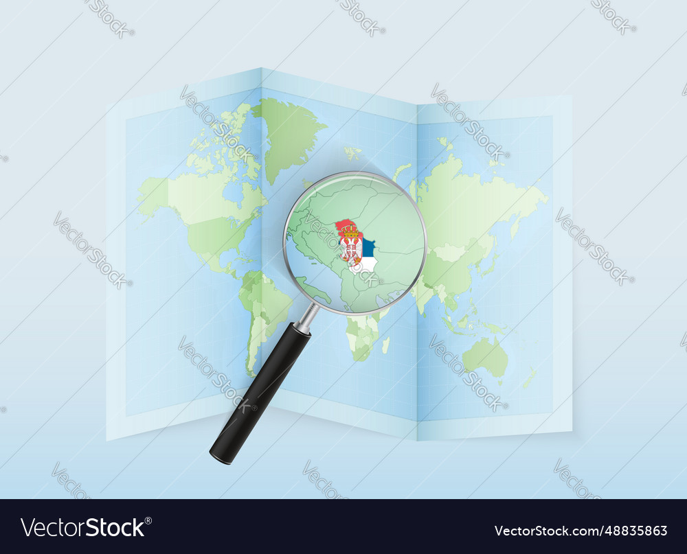 A folded world map with magnifying lens