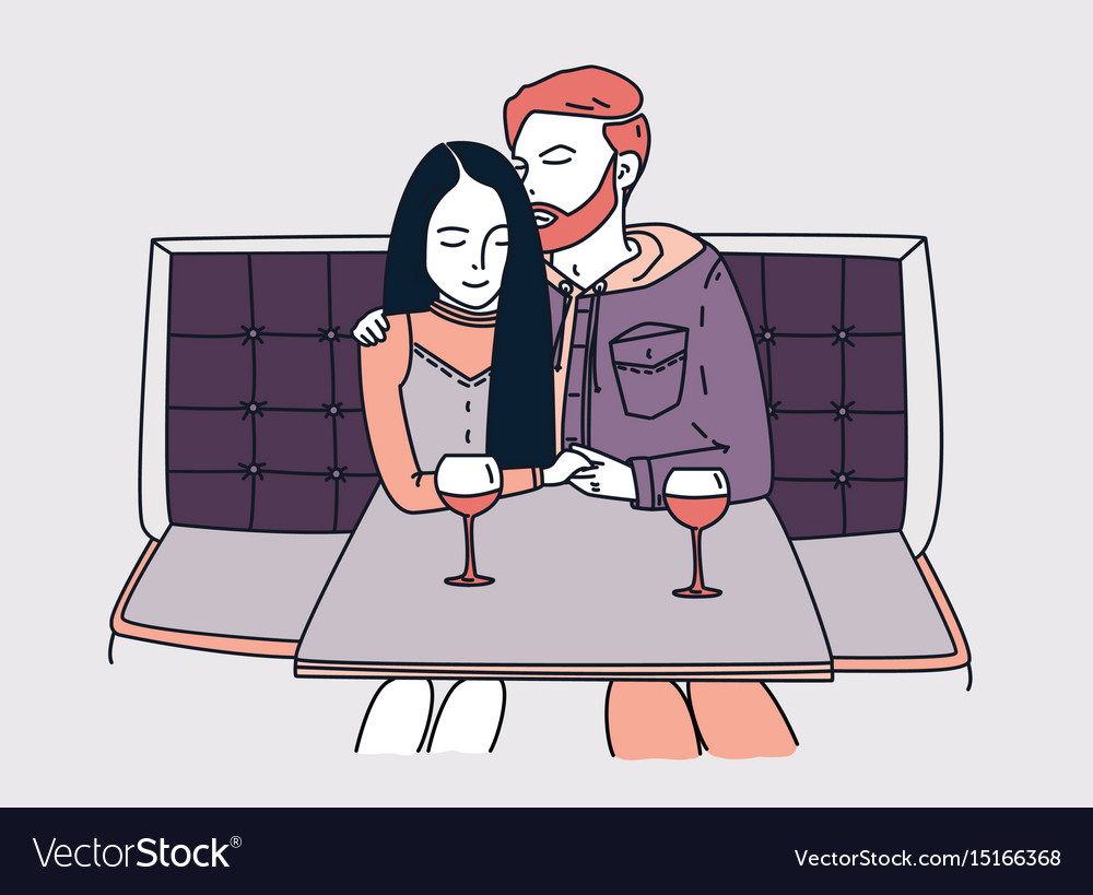 Young couple sits in a cafe and drinks wine