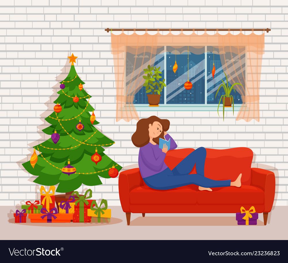 Young woman reading book sitting on the sofa