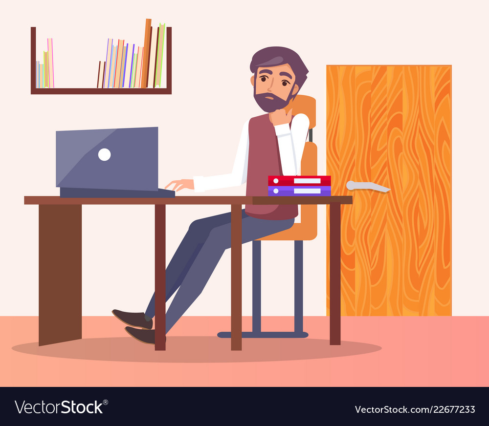 Man Typing at Office Desk with Bookshelf