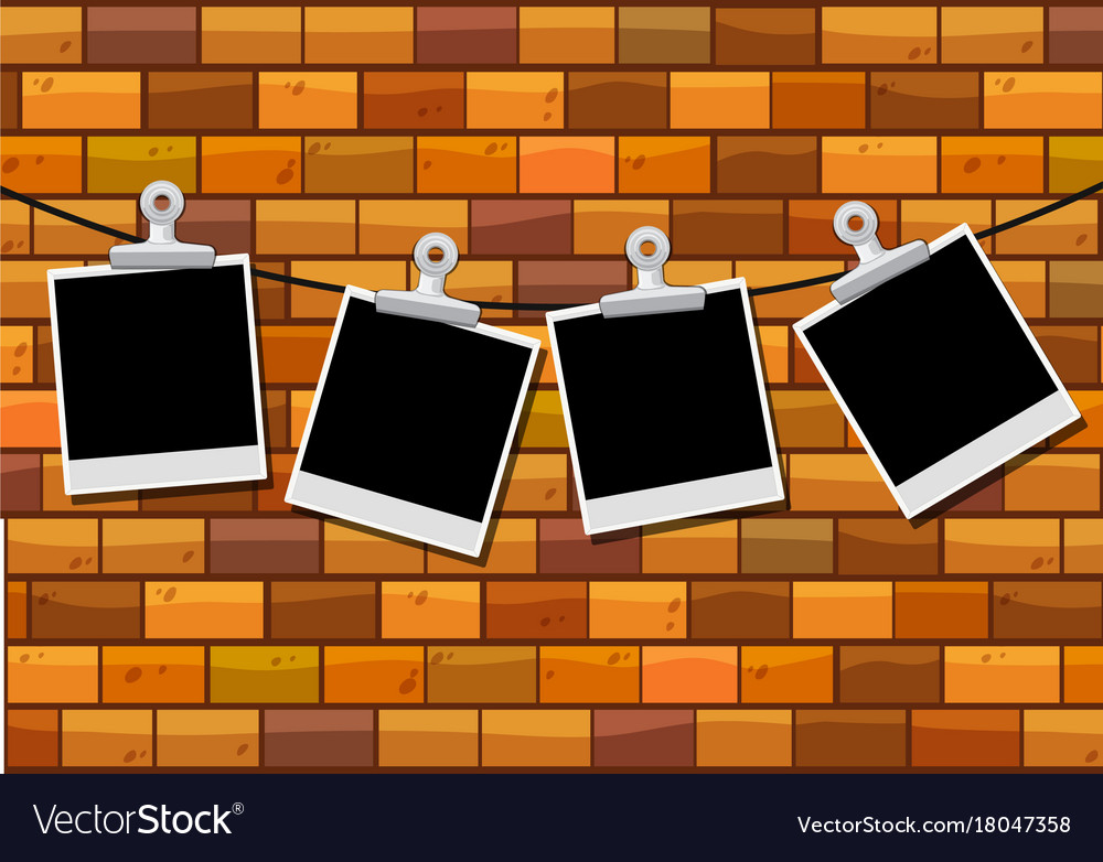 Photo Frames Hanging On Brick Wall