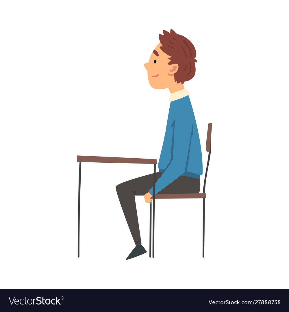 Boy Sitting at Desk in Classroom