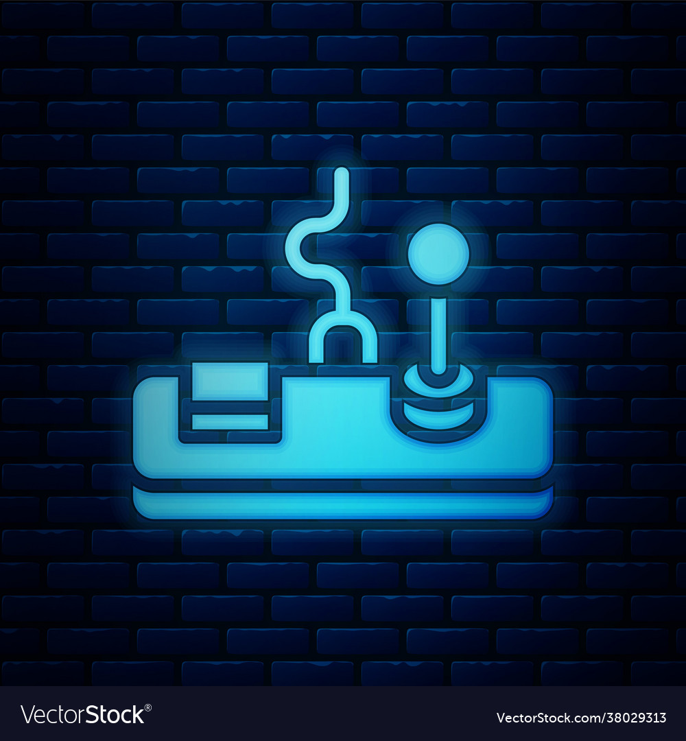 Glowing neon gamepad icon isolated on brick wall