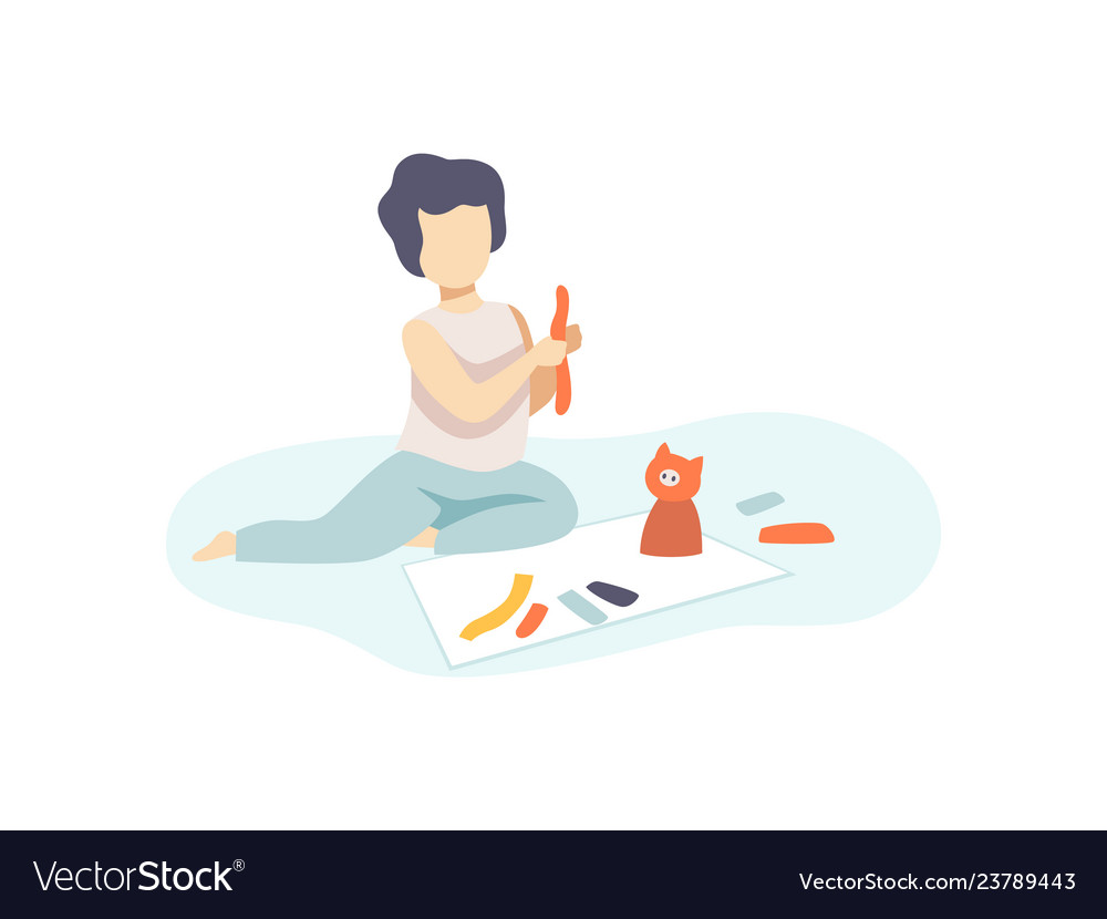 Cute boy sitting on floor and making figures from