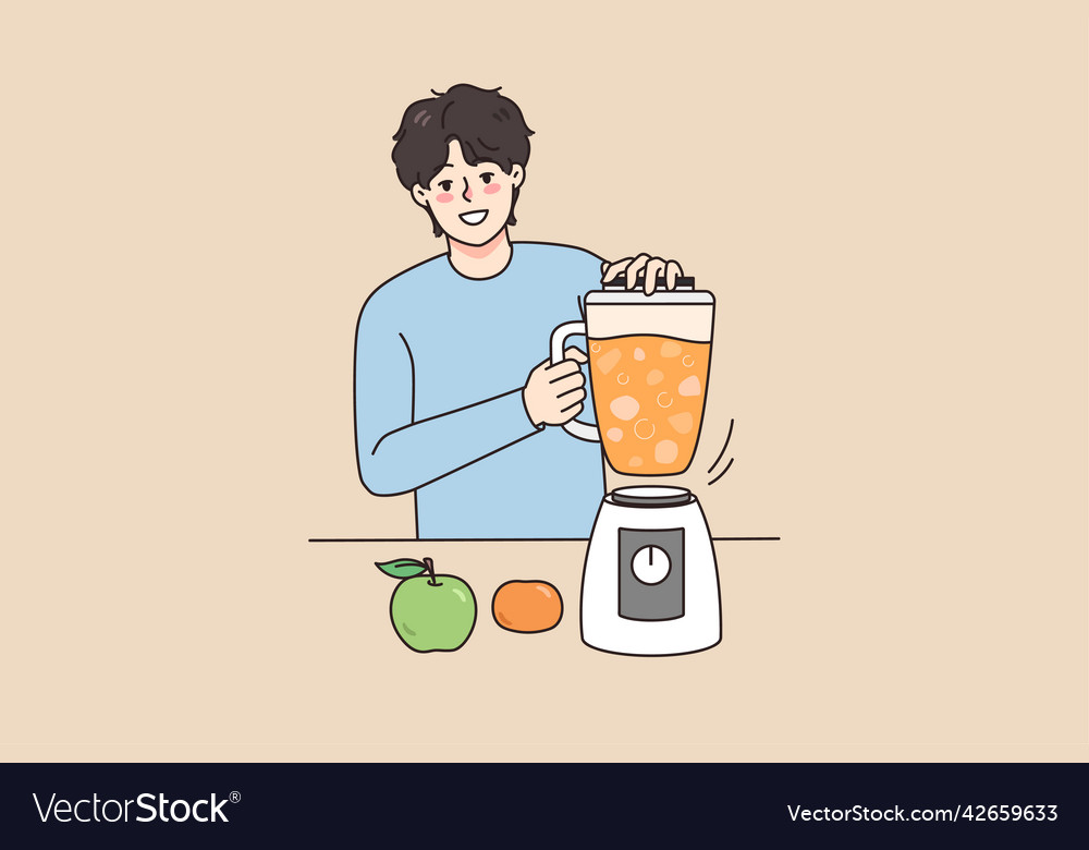 Smiling man making fruit juice in blender