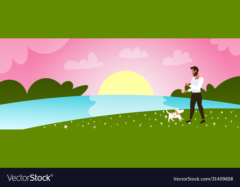 Young man walking with dog outdoors at park guy