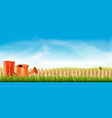 rubber boots with watering can in a green grass vector image vector image