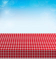 picnic table covered with checkered tablecloth vector image