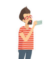 casual man holding mobile phone gadget in hand vector image
