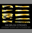 set of golden paint strokes to make a background vector image