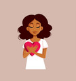 african woman holding a big heart symbol vector image vector image