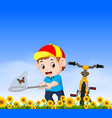 young boy with bicycle catching butterfly vector image vector image