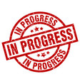 in progress round red grunge stamp vector image