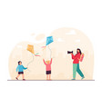 mother taking picture of daughters playing game vector image vector image