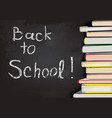 back to school written on chalkboard with books vector image