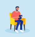 man sitting on a chair and uses tablet pc vector image